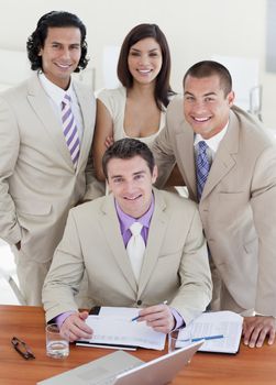 Assertive business people studying a document in a meeting