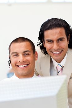 Close-up of happy businessmen working together at a computer