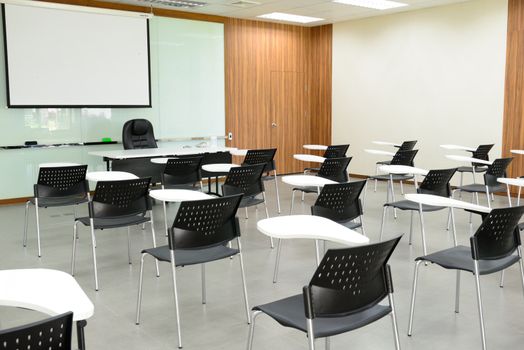 The empty modern classroom with many chairs.