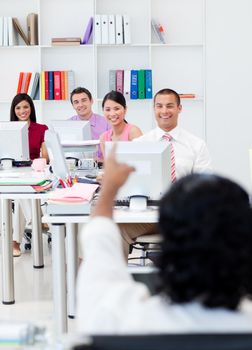 Happy business people working at computers in the office