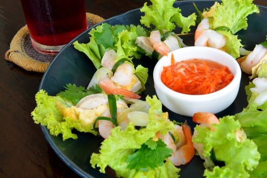 Vietnam food style call " Shrimp salad" served on the black wooden table