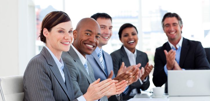 Portrait of an international business team clapping in a meeting