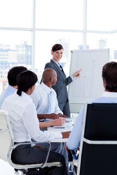 Smiling business woman doing a presentation to her colleagues in the office