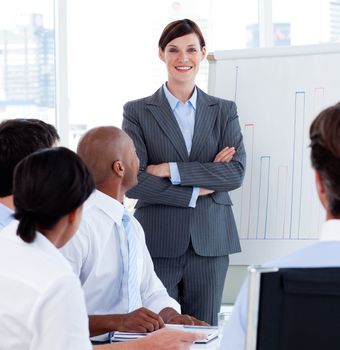 Female executive smiling at the camera at a meeting