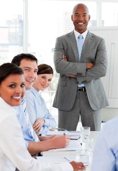 International business team smiling at the camera in a meeting