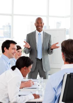 Smiling businessman doing a presentation to his colleagues in the office