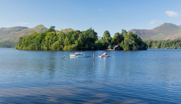 Piers and boats on edge of Derwentwater in English Lake District in early morning