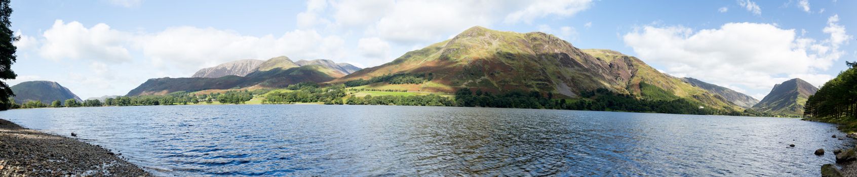 Mountains reflect into Buttermere calm lake in English Lake District