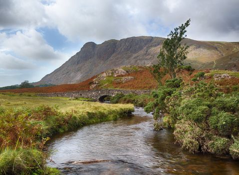 Ancient stone bridge over river running into Wastwater in Lake District