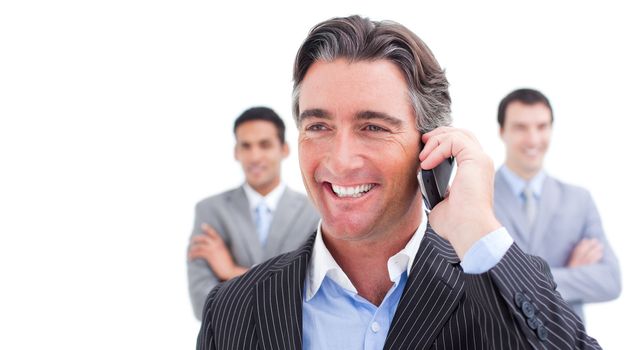 Smiling businessman talking on phone against a white background