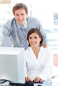 Confident manager helping his colleague  in the office