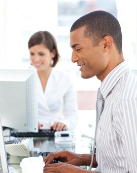 Two positive colleagues working at a their computer in the office
