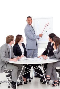 Smiling businessman reporting sales figures to his team