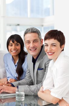 A diverse business team sitting in a row in the office