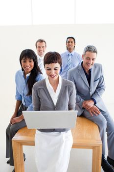 Multi-ethnic business team using a laptop in the office