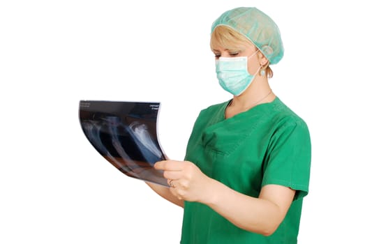 Female doctor with mask examining x-ray
