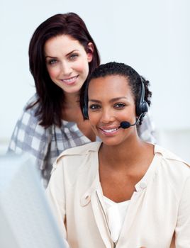 Charming business people working at a computer in the office