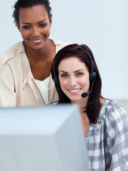 Smiling business partners working at a computer in the office