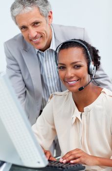 Smiling business people working at a computer in the office