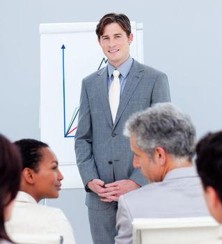 Confident businessman doing a presentation to his colleagues