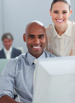 Assertive business partners working at a computer together in the office