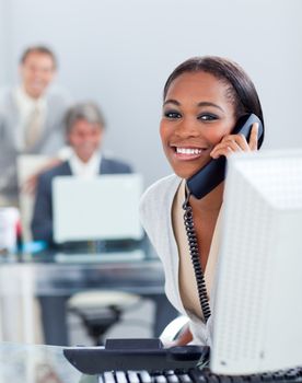 Beautiful businesswoman on phone at her desk in the office