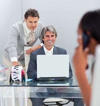 Charismatic businessmen working at a computer together in the office