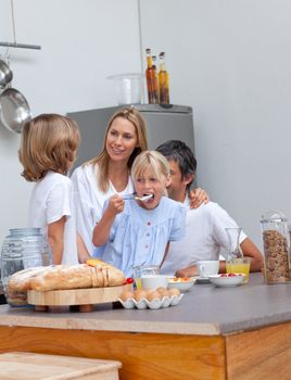 Jolly family having breakfast in the kitchen