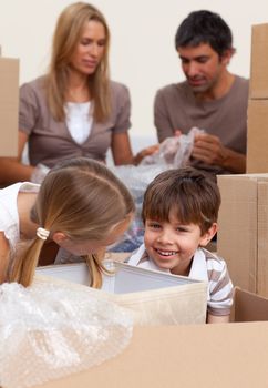 Smiling siblings having fun during house moving at home