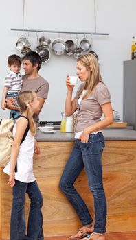 Family talking in the kitchen before going to school during breakfast