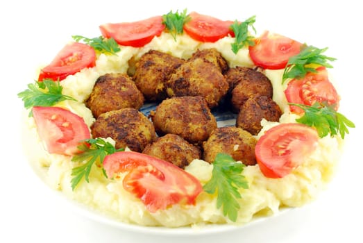 Meatballs with potato and tomatoes studio shot