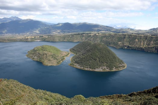 The blue waters and the channel between the two islands in lake Cuicocha, a crater lake near Cotacachi, Ecuador