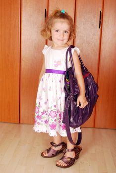 Beauty little girl with big bag and shoes