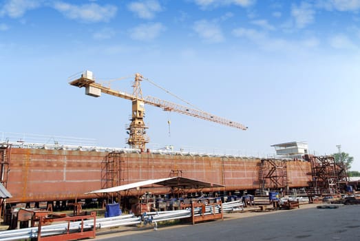 Shipyard with crane and tanker