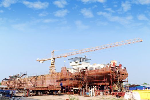 Heavy industry shipyard with crane and tanker