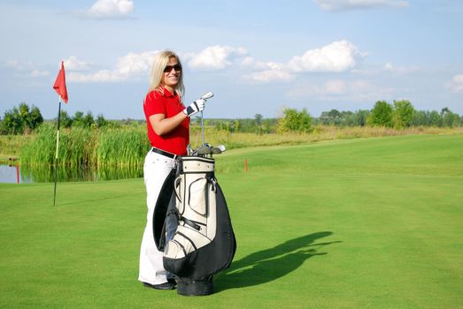 Beauty girl golf player with golf bag