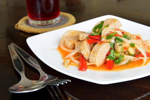 Thai food call "Mince pork spicy salad" is served on the wooden black table.