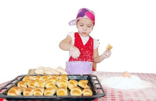 Little girl make rolls with flour