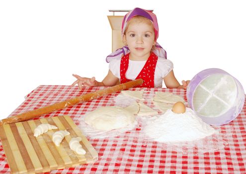 Little girl with flour and rolls studio shot