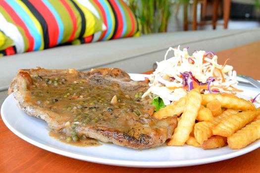 T-Bone steak served with green pepper corn sauce,Thai style steak