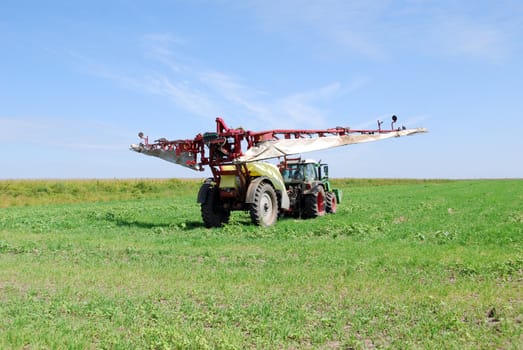 Tractor with sprayer preparing for work
