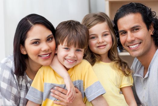 Close-up of a family hugging in the kitchen at home