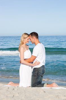 Romantic couple hugging on the sand. Love concept.