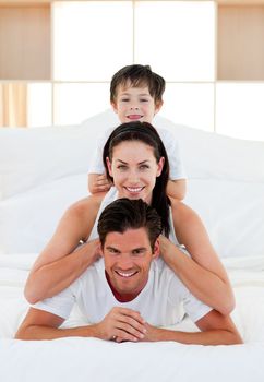 Family having fun lying on the bed