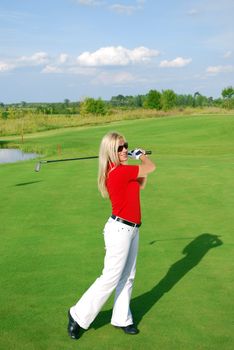 Young blonde girl play golf
