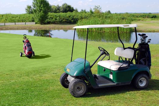 Golf buggy and golf bag on golf field