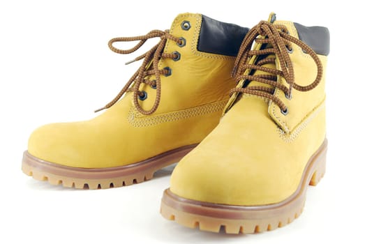 Yellow hiking boots on white