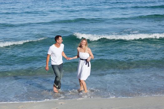 Romantic couple walking together at the seaside