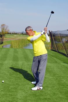 Golfer ready for hit yellow golf ball