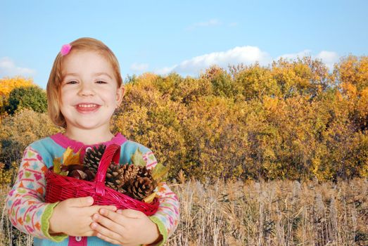 Beauty little girl with autumn forest behind